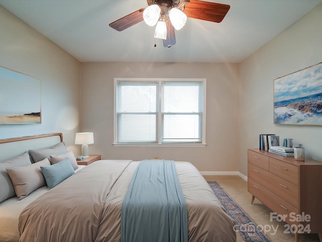 bedroom featuring light colored carpet and ceiling fan