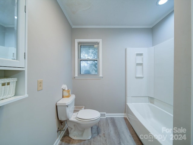 bathroom featuring shower / bathtub combination, wood-type flooring, toilet, and crown molding