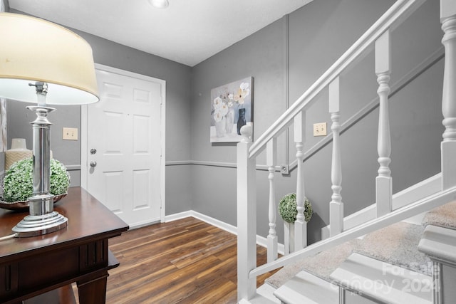 foyer entrance with dark wood-type flooring