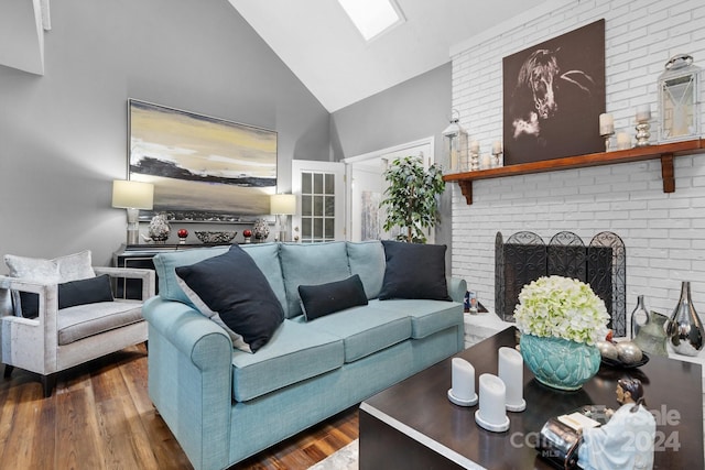 living room featuring a brick fireplace, high vaulted ceiling, and dark hardwood / wood-style flooring