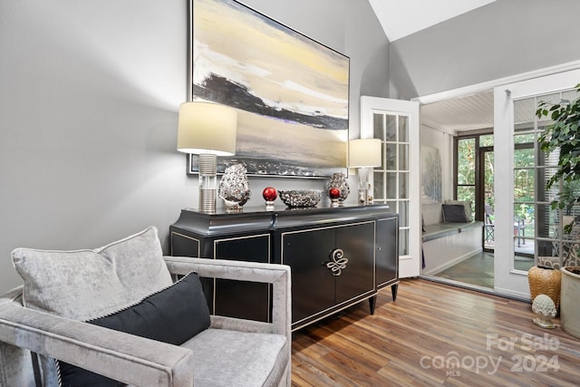 sitting room featuring dark hardwood / wood-style floors and lofted ceiling