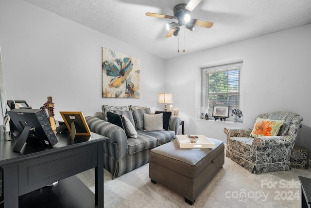 carpeted living room featuring a textured ceiling and ceiling fan