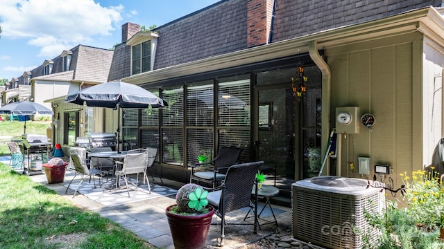 view of patio with grilling area and cooling unit