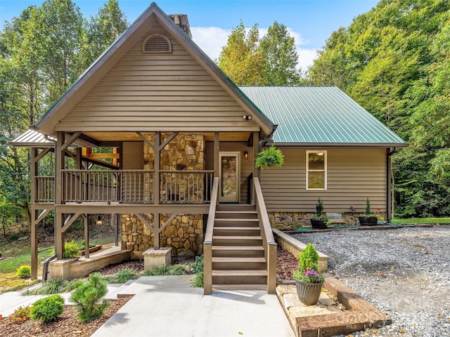 rustic home featuring metal roof and stairway