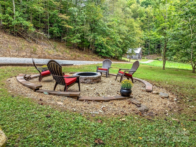 view of yard with a fire pit