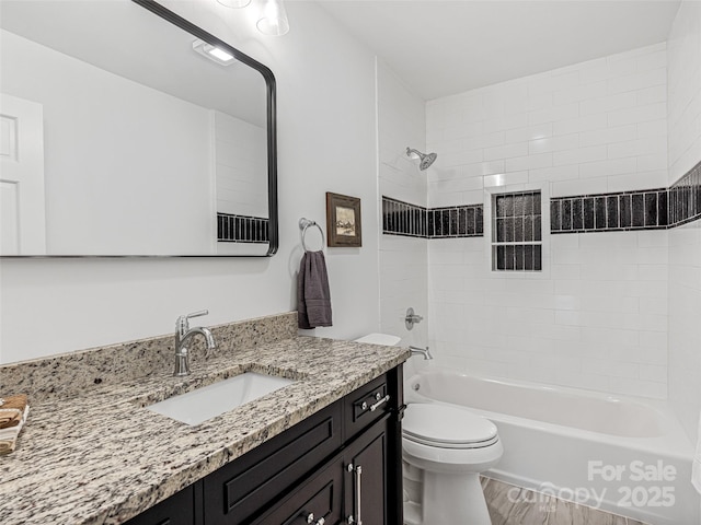 bathroom featuring tub / shower combination, vanity, and toilet