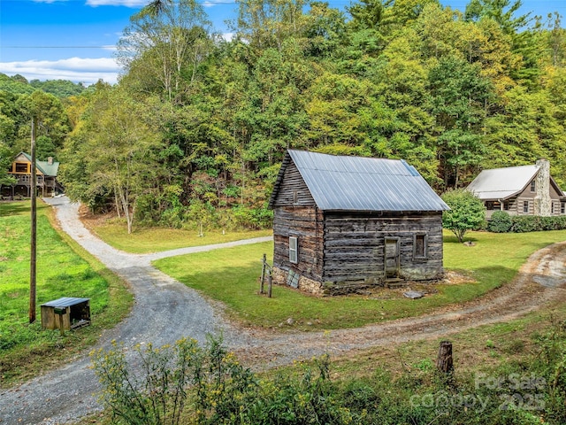 view of outbuilding featuring driveway and an outdoor structure