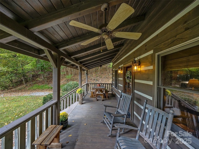 wooden deck with a ceiling fan