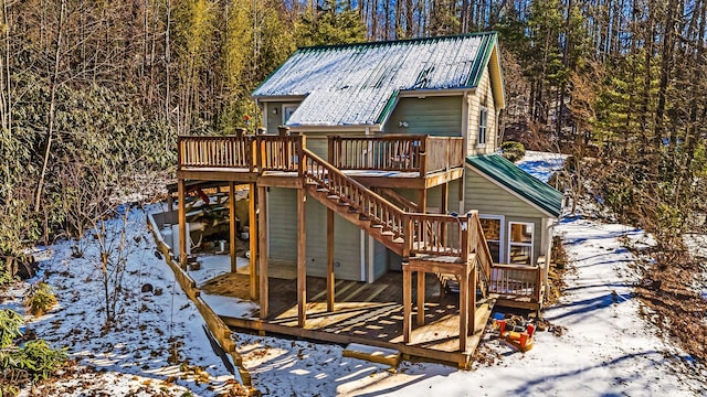 snow covered playground featuring a wooden deck