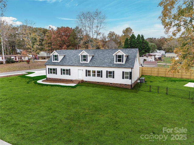 rear view of property with cooling unit and a lawn