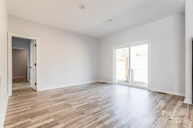 empty room with light hardwood / wood-style floors