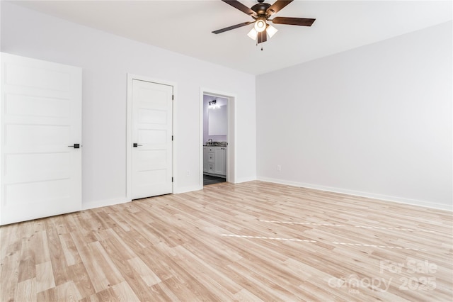 unfurnished bedroom featuring ceiling fan, connected bathroom, and light hardwood / wood-style flooring