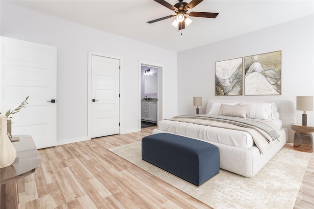 bedroom featuring hardwood / wood-style flooring, ceiling fan, and ensuite bathroom