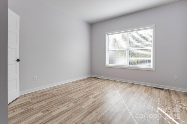 unfurnished room with light wood-type flooring