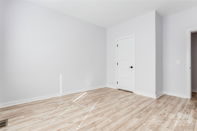 spare room with light hardwood / wood-style flooring