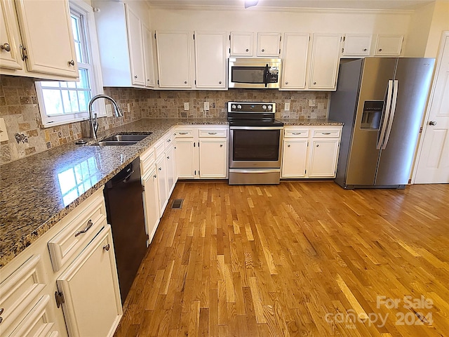 kitchen featuring stone countertops, white cabinetry, sink, and appliances with stainless steel finishes