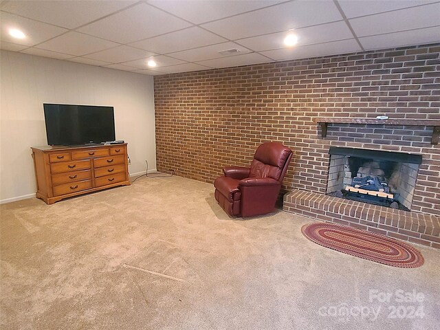 sitting room with a paneled ceiling, carpet flooring, and a fireplace