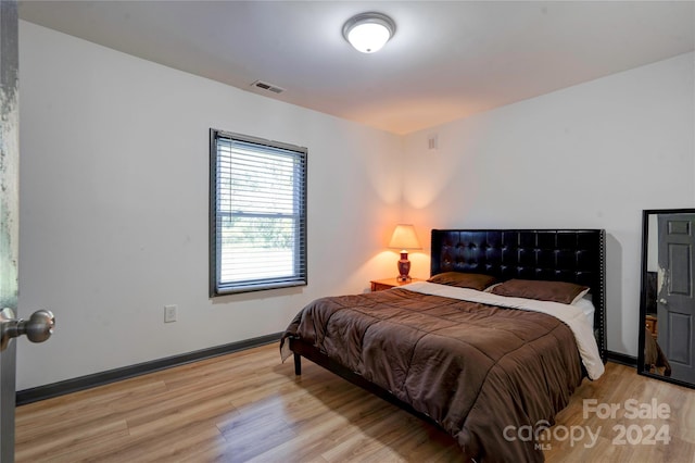 bedroom with light hardwood / wood-style floors