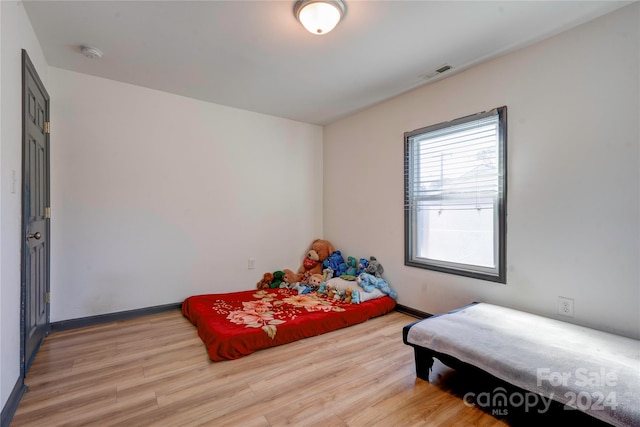 bedroom with wood-type flooring