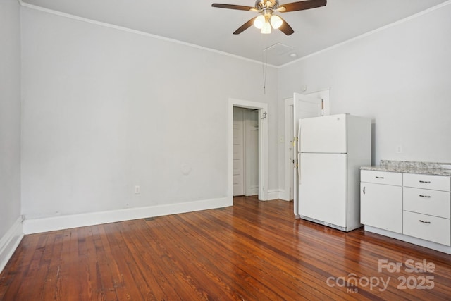 interior space with crown molding, ceiling fan, and dark hardwood / wood-style floors