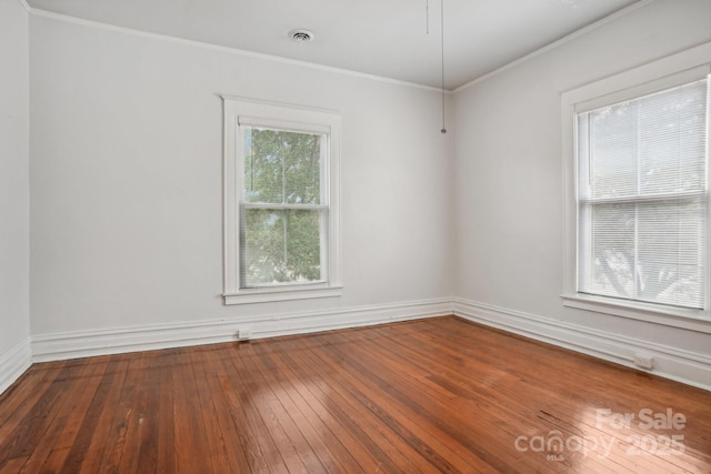 spare room featuring hardwood / wood-style flooring and crown molding