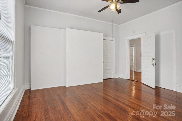 unfurnished room with crown molding, ceiling fan, and dark hardwood / wood-style flooring