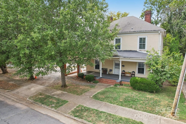 view of front of house featuring a front yard and covered porch