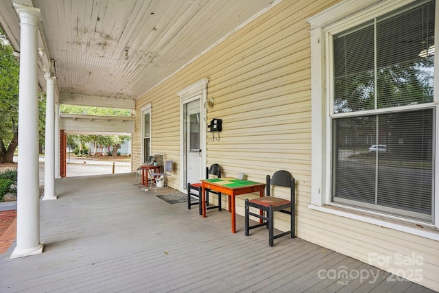 wooden terrace featuring covered porch