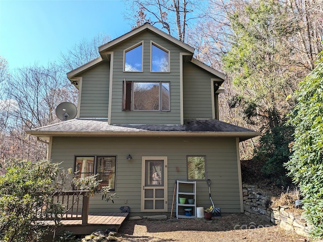 back of property with a wooden deck