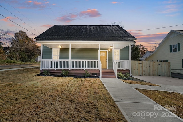 bungalow with a lawn and covered porch