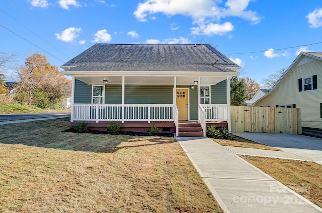 bungalow-style home with a porch and a front lawn