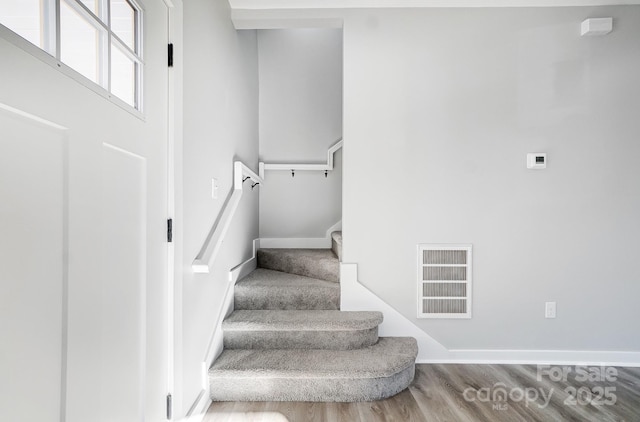 staircase featuring hardwood / wood-style flooring