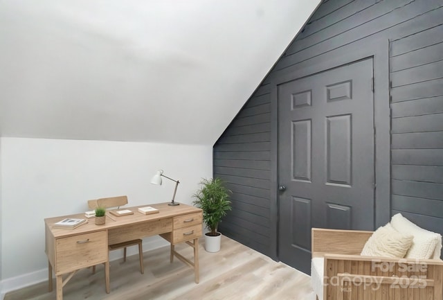 home office with lofted ceiling and hardwood / wood-style floors