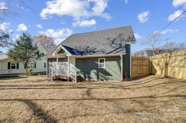 rear view of house featuring a lawn