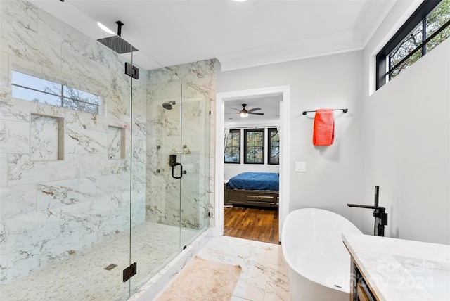 bathroom featuring vanity, hardwood / wood-style flooring, ceiling fan, ornamental molding, and shower with separate bathtub