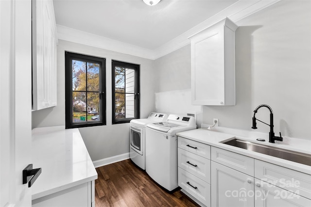 laundry area featuring cabinets, dark hardwood / wood-style flooring, ornamental molding, sink, and independent washer and dryer