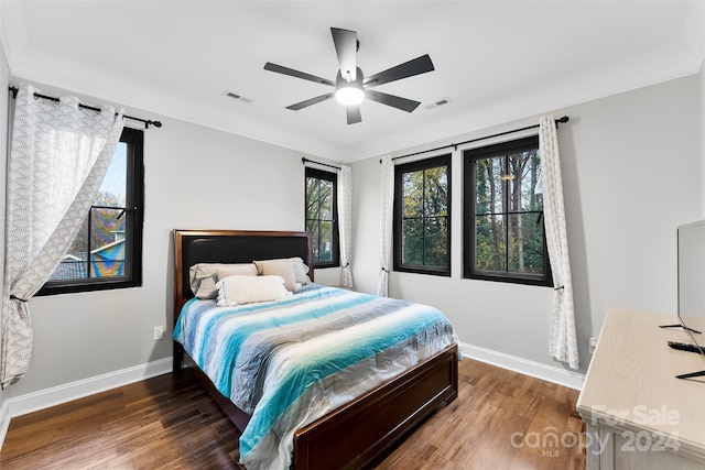 bedroom featuring a barn door, ceiling fan, dark hardwood / wood-style flooring, and crown molding