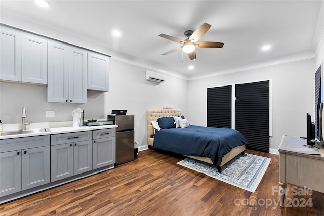 bedroom featuring stainless steel fridge, dark hardwood / wood-style flooring, a wall unit AC, crown molding, and sink