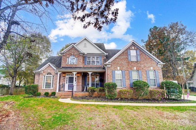 view of front of property with covered porch and a front lawn