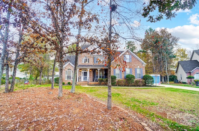 view of front of home with a front yard and covered porch