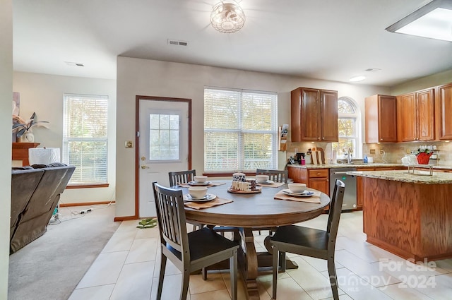 dining space with light tile patterned floors and sink