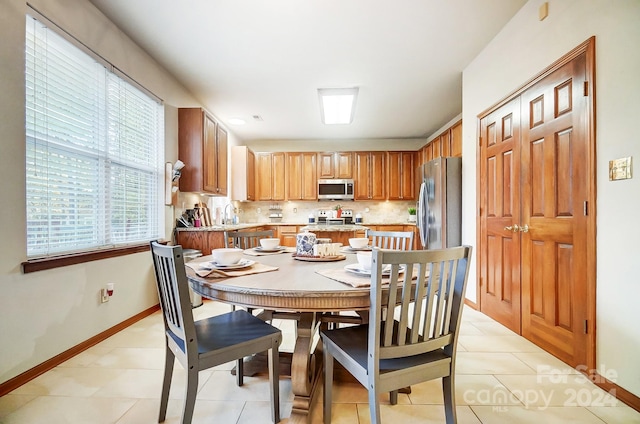 tiled dining space featuring sink