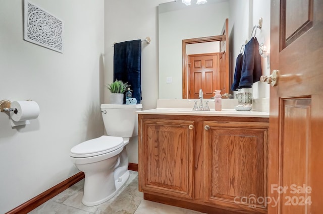 bathroom featuring tile patterned floors, vanity, and toilet