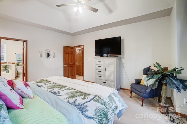 carpeted bedroom with ensuite bath and ceiling fan