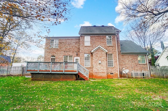 rear view of house with a deck and a lawn