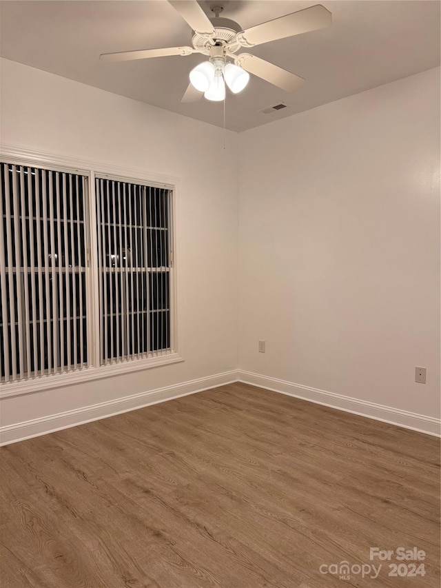 spare room featuring hardwood / wood-style flooring and ceiling fan