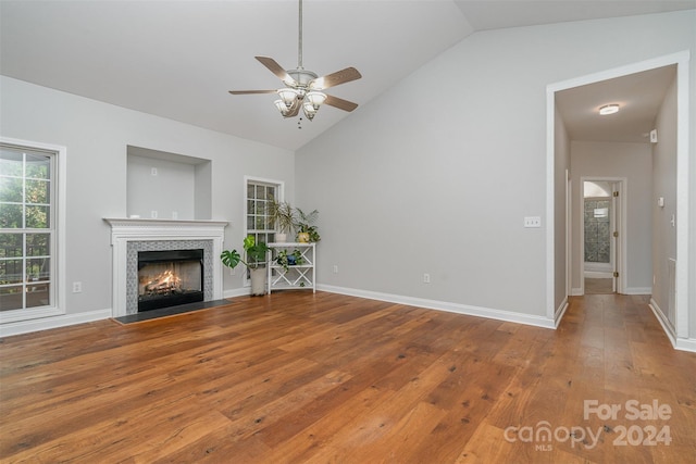 unfurnished living room with hardwood / wood-style floors, vaulted ceiling, and ceiling fan