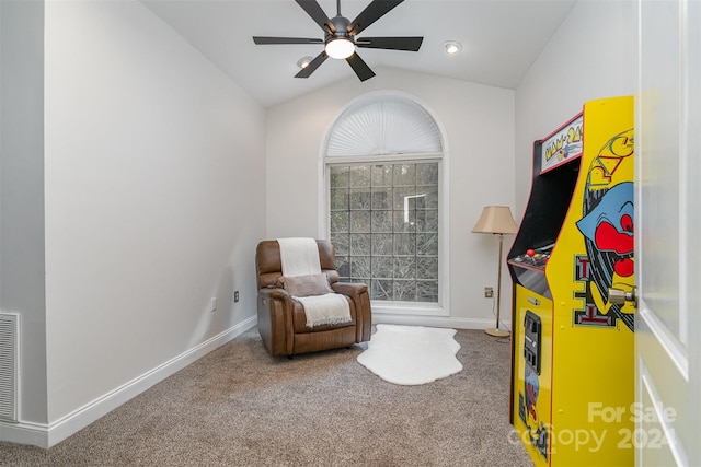 living area with lofted ceiling, ceiling fan, and carpet floors