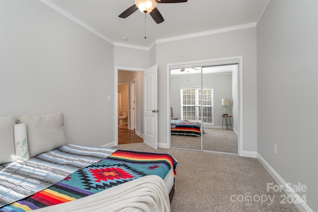 carpeted bedroom featuring ornamental molding, ceiling fan, and a closet