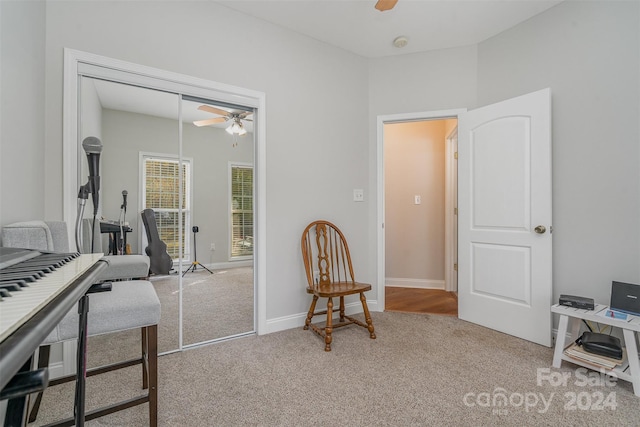 interior space with carpet flooring and ceiling fan